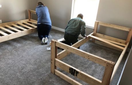 Volunteers assist in building beds donated to The Farm Place by Sleep in Heavenly Peace